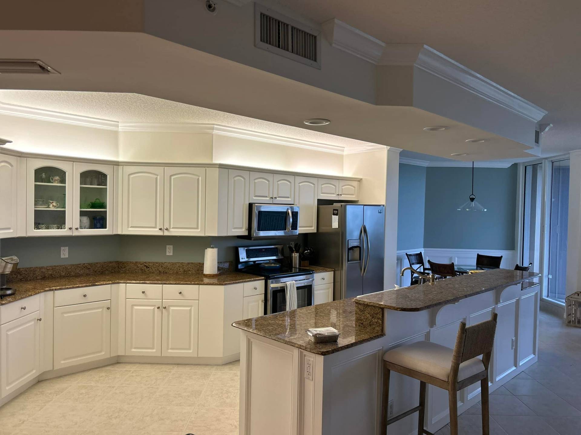 Bright white cabinet refacing in an open-concept Treasure Coast kitchen by Millman Services